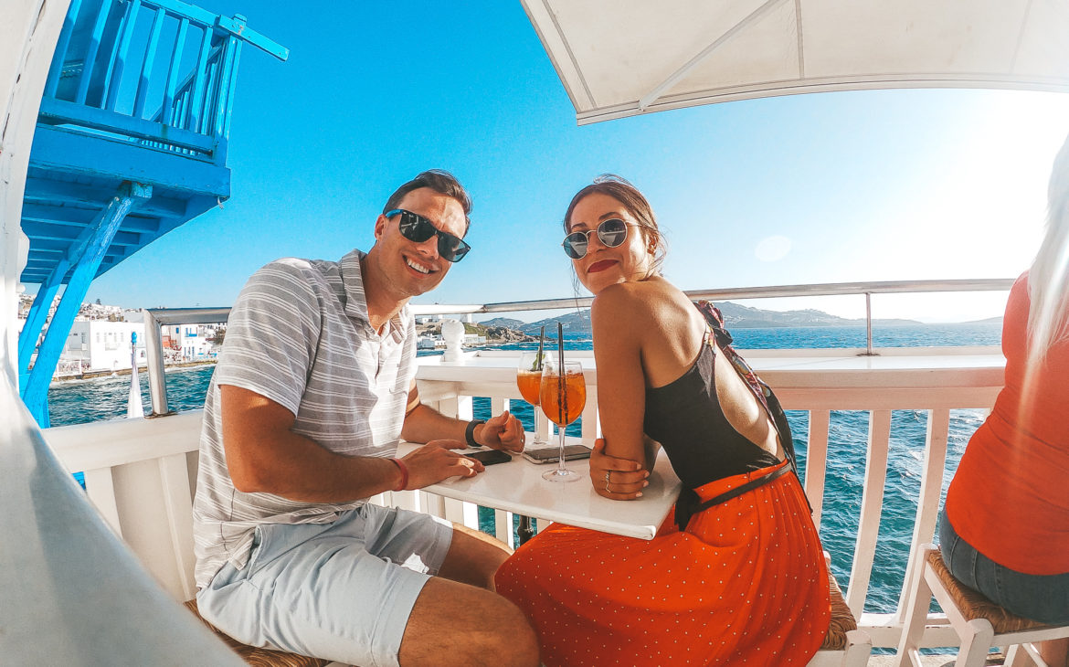 burnette couple at a restaraunt on their  honeymoon in greece